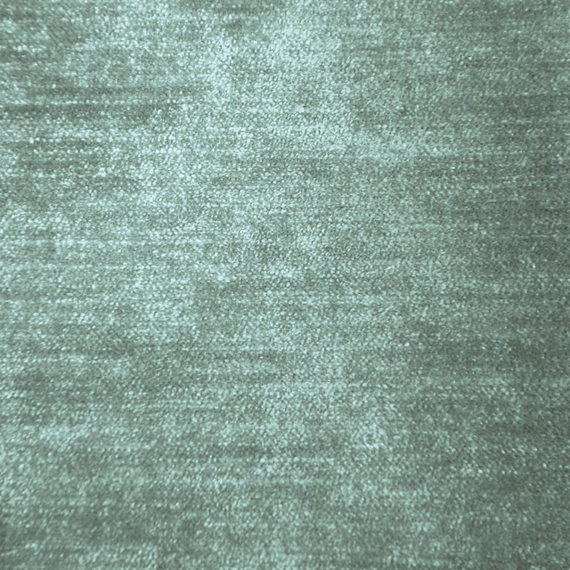 Soft sage-green fabric with a subtle lustre and mottled plain weave