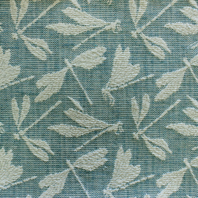 Teal woven fabric swatch with cream leaf motif and textured surface