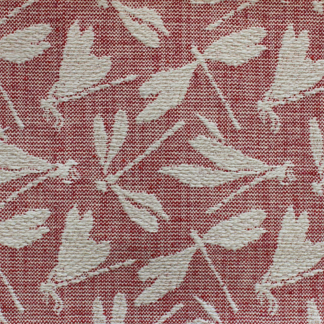 Close-up of red woven fabric with pale leaf motif and textured surface