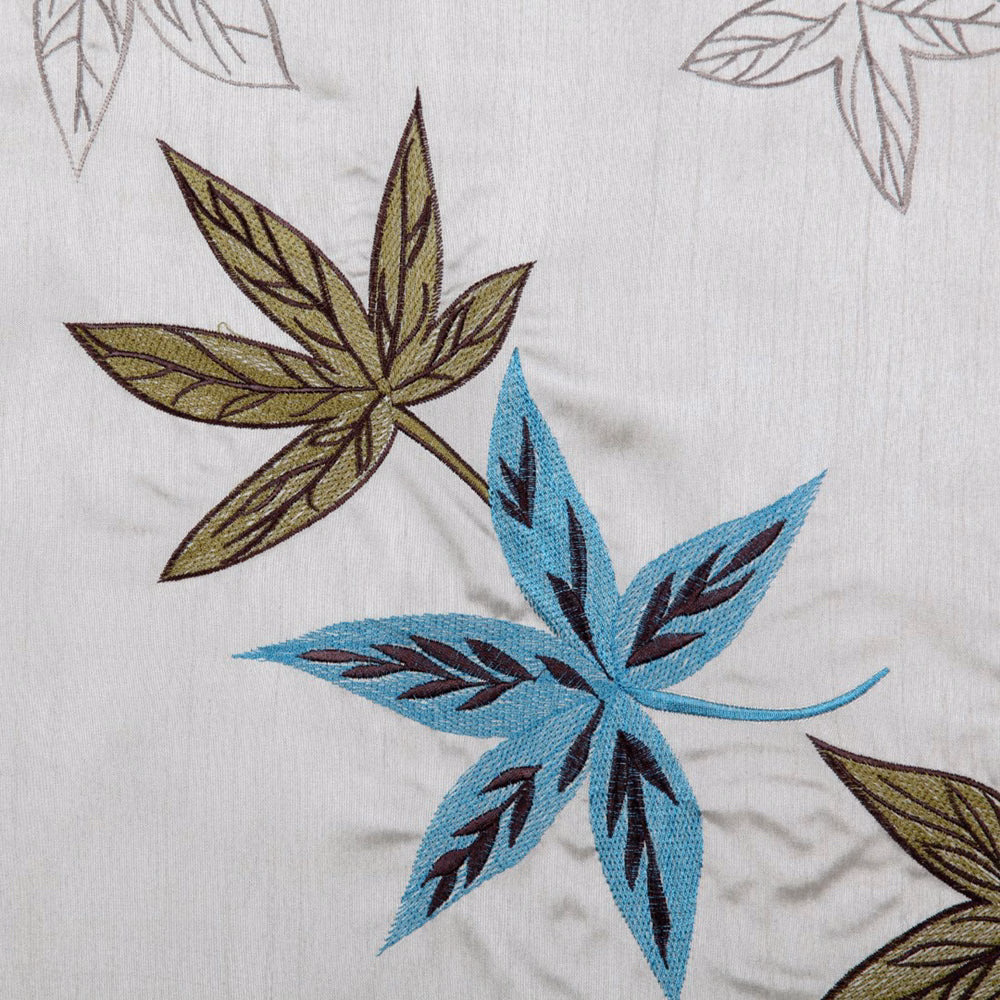 Embroidered aqua and olive leaf motif on a pale neutral fabric ground