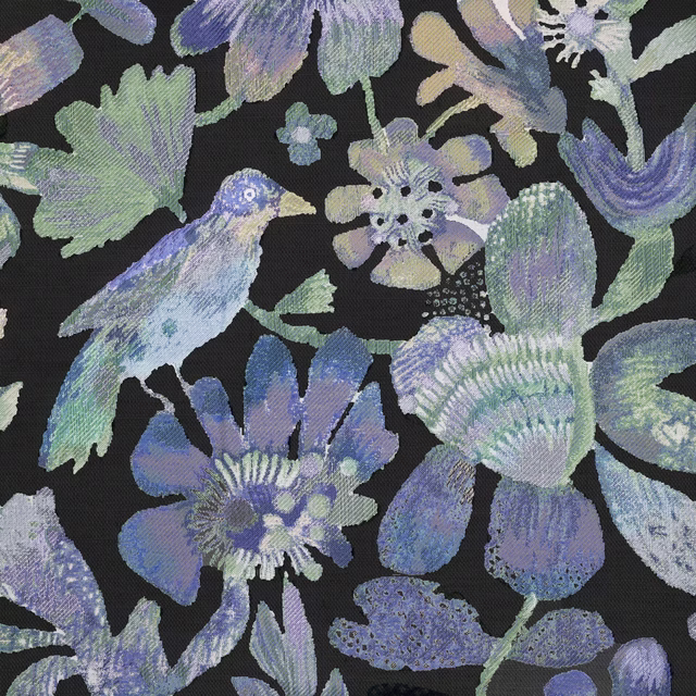 Painterly floral fabric with lilac, blue and mint motifs on a black ground