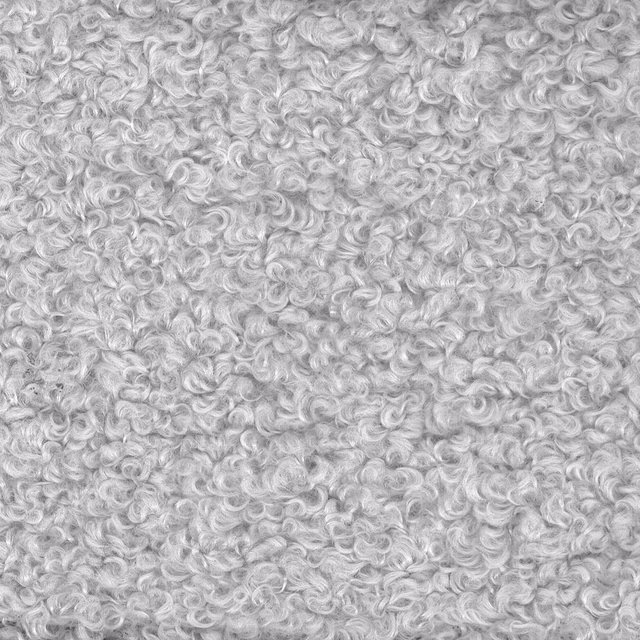 Close-up of soft silver grey curly bouclé-style fabric texture
