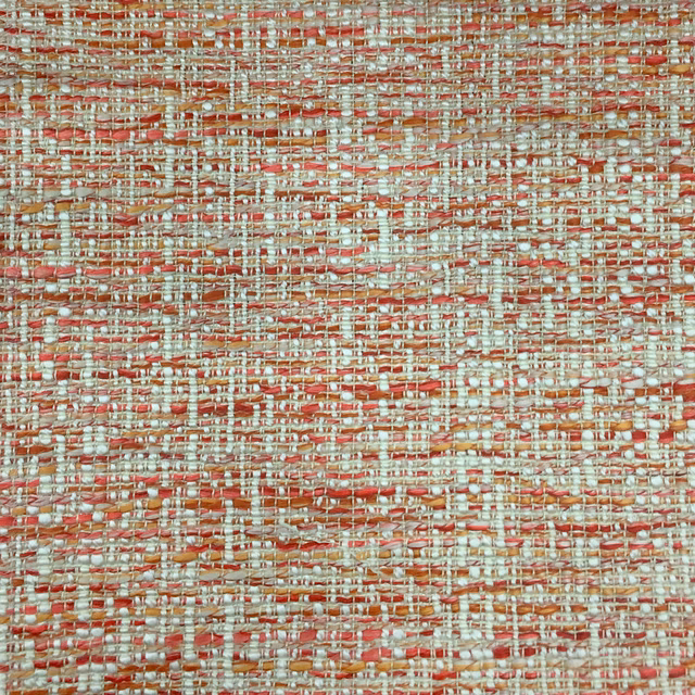 Close-up of a textured coral-orange woven fabric with cream and terracotta threads