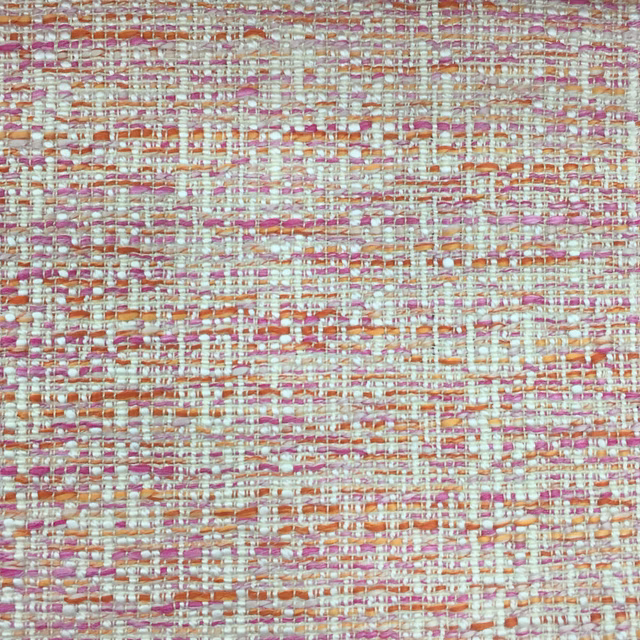 Close-up of a pink and cream textured woven fabric with coral flecks