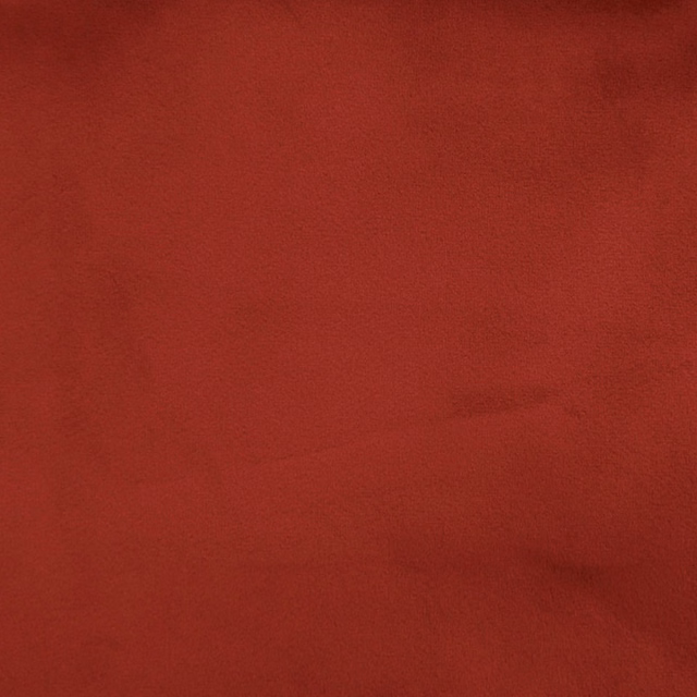 Deep warm red plain fabric with a smooth, matte surface