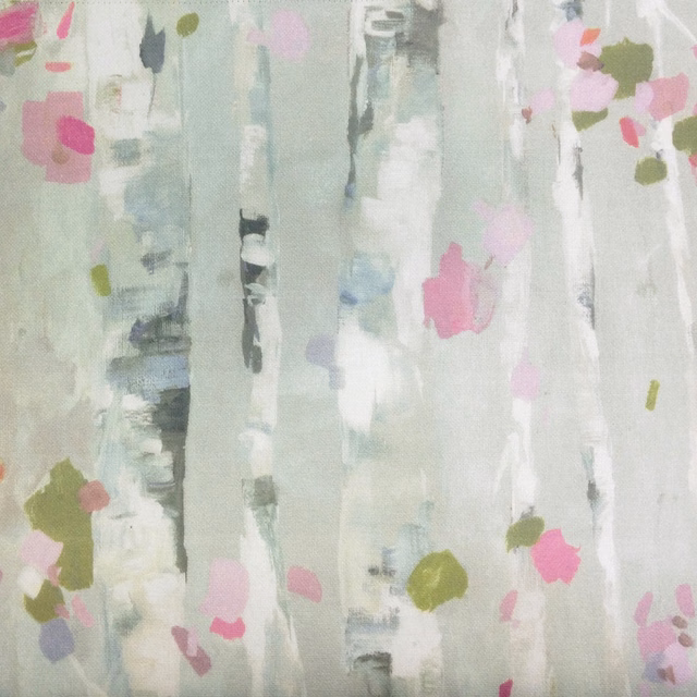 Abstract grey fabric swatch with pastel pink, olive and pale blue painterly marks