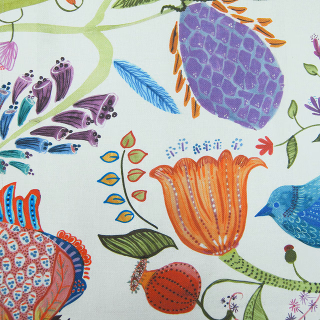 Colourful bird and flower print on an ivory woven fabric ground