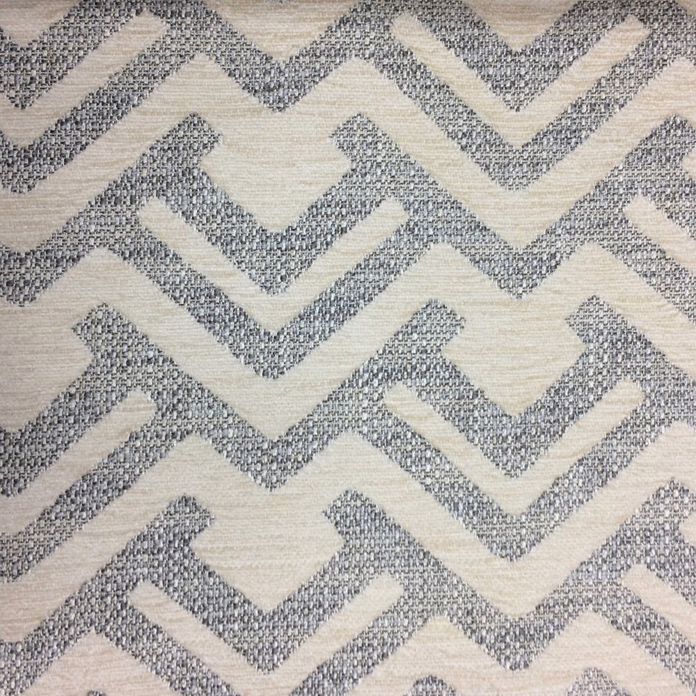 Soft grey zigzag woven fabric on a pale ground with textured surface