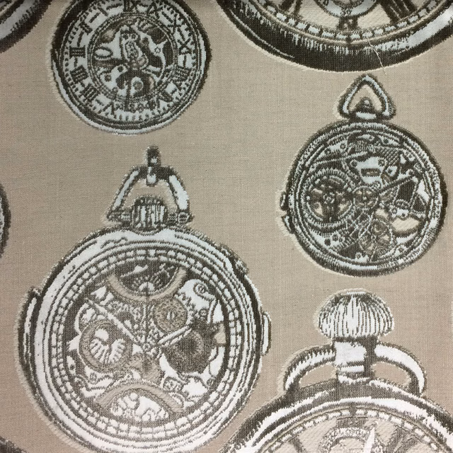 Beige patterned fabric with circular antique-style motifs in olive brown and chalk