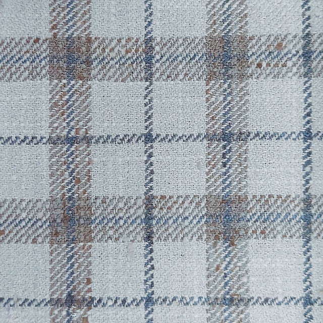 Close-up of pale grey checked woven fabric with blue and taupe threads