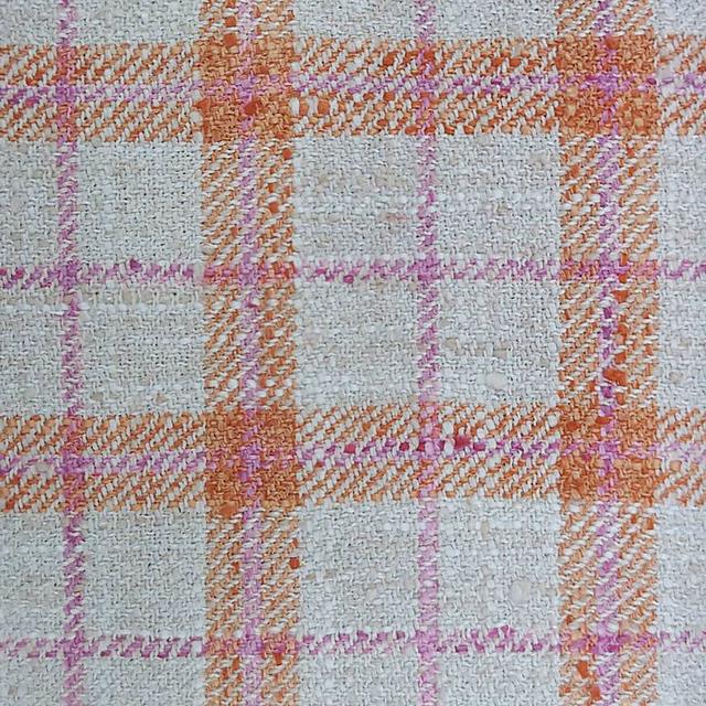 Cream woven check fabric with orange-coral and pink plaid lines