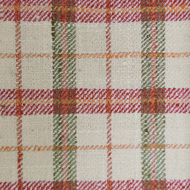 Cream tartan fabric with red, green and orange woven checks