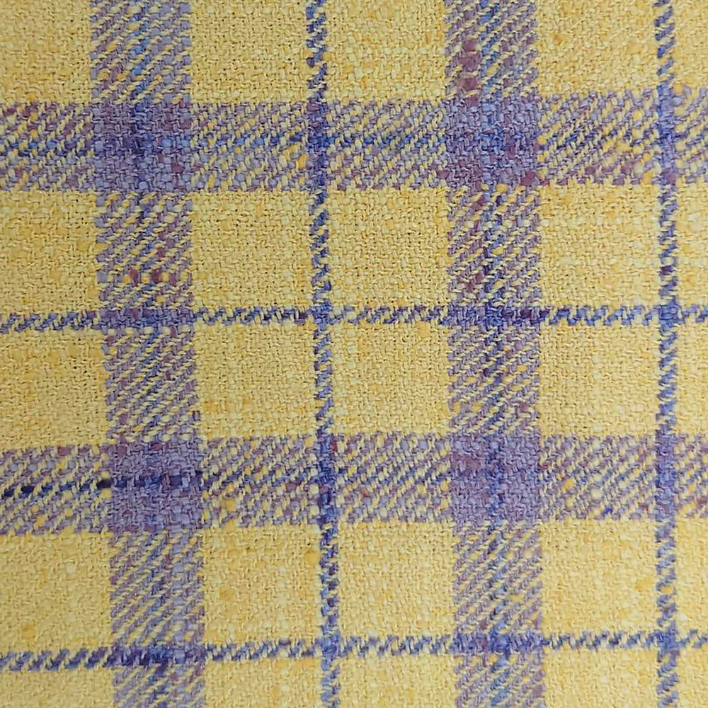 Close-up of yellow and lilac checked woven fabric with a textured finish