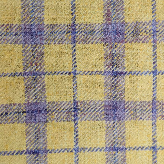 Close-up of yellow and lilac checked woven fabric with a textured finish