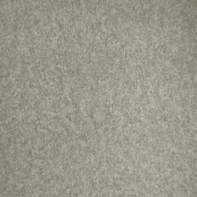 Close-up of warm beige textured woven fabric with soft mottled finish