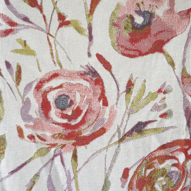 Close-up of painterly red and blush floral fabric on an off-white woven ground