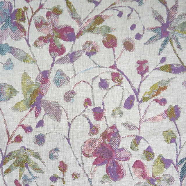 Pale woven floral fabric with lilac, sage and plum leaves on an ivory ground