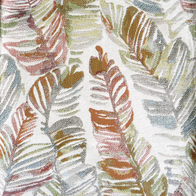 Painterly multi-coloured leaf pattern on a pale woven fabric ground