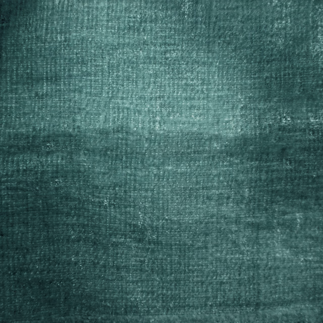Close-up of deep teal-blue woven fabric with a softly mottled texture