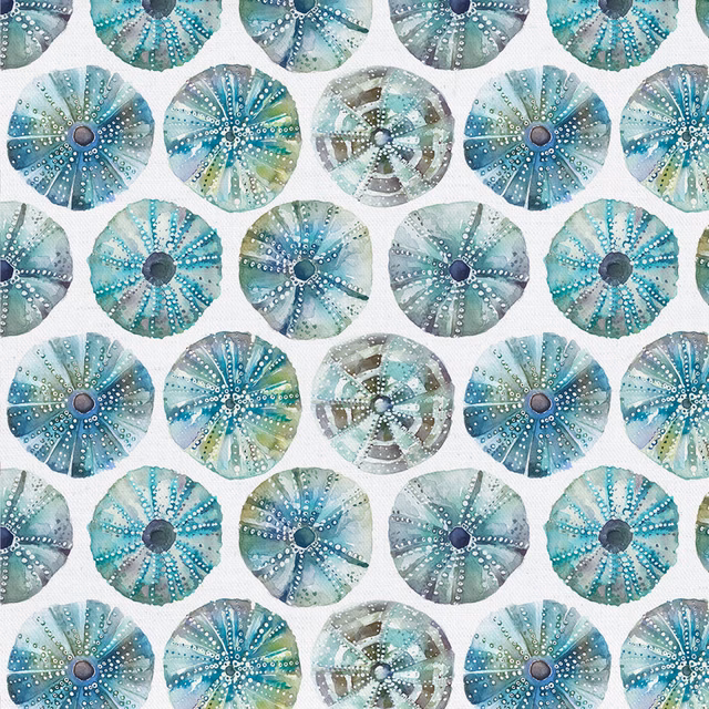 White cotton fabric with repeated sea urchin circle motifs in aqua and blue tones