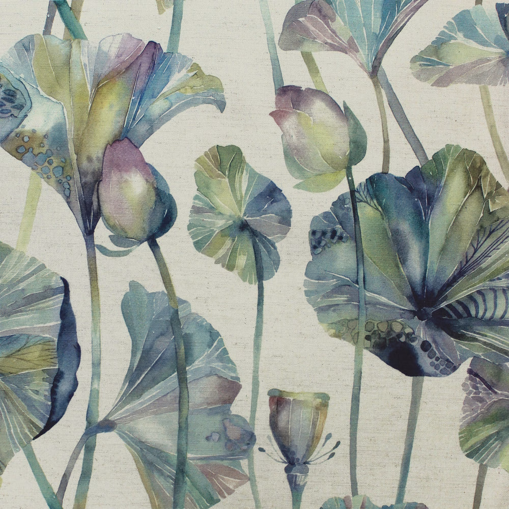 Painterly blue-green botanical fabric with large leaf motifs on a pale ground
