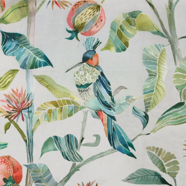 Botanical fabric with green leaves and a colourful bird on a pale ground