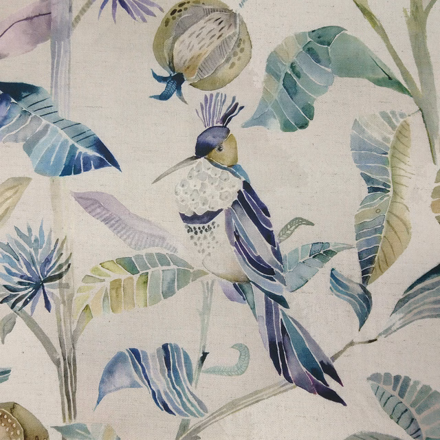 Painterly bird and tropical leaf print in lilac, indigo and teal on pale ground