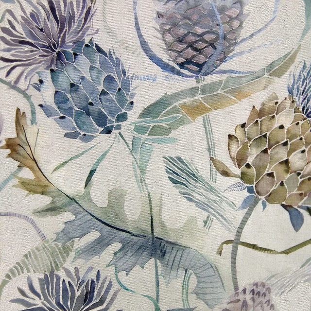 Painterly botanical fabric with blue-green seed heads and pale ground
