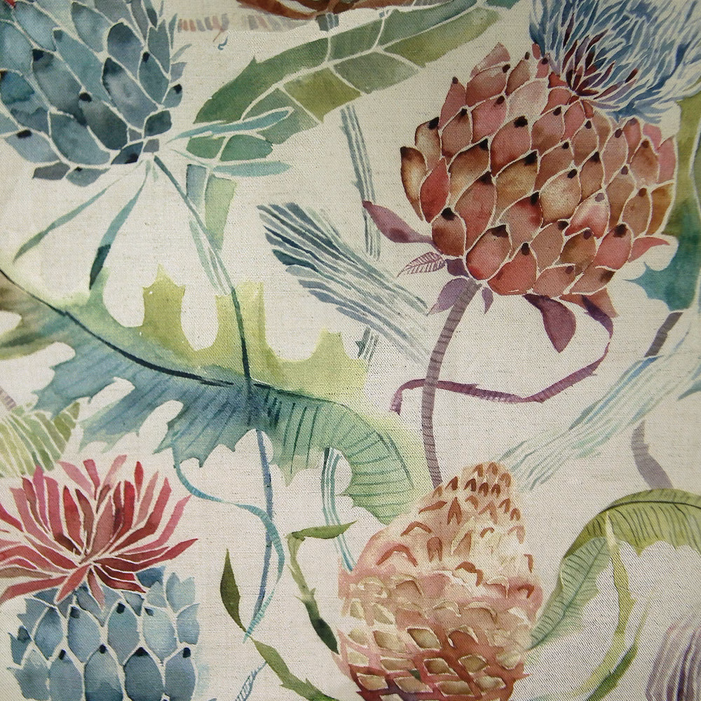 Painterly floral fabric with terracotta orange blooms and green leaves on a pale ground