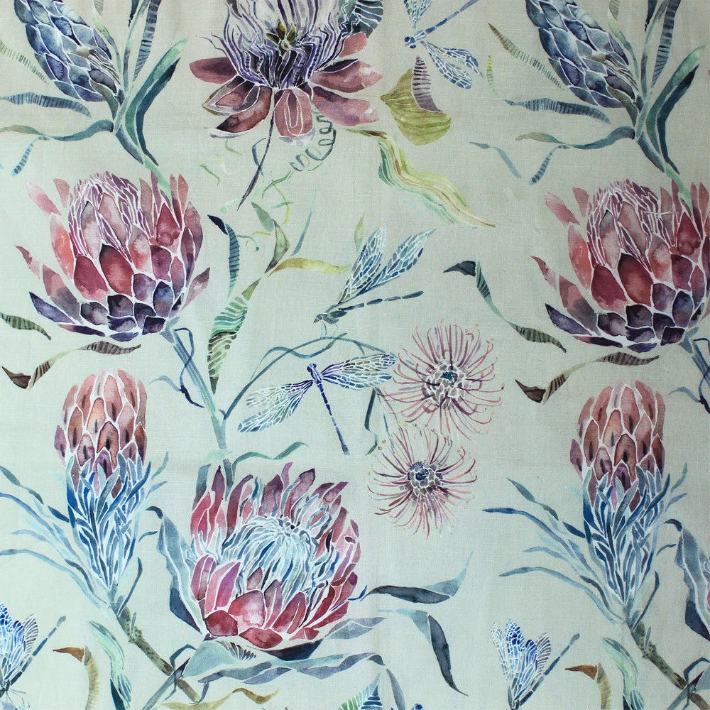 Painterly botanical fabric with large pink protea blooms on a pale blush ground