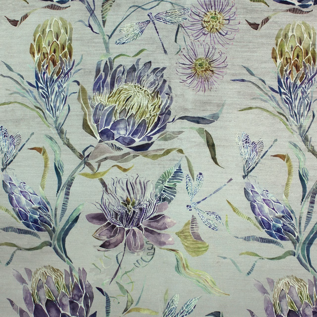 Painterly lilac and purple floral fabric on a pale ground with green-blue leaves