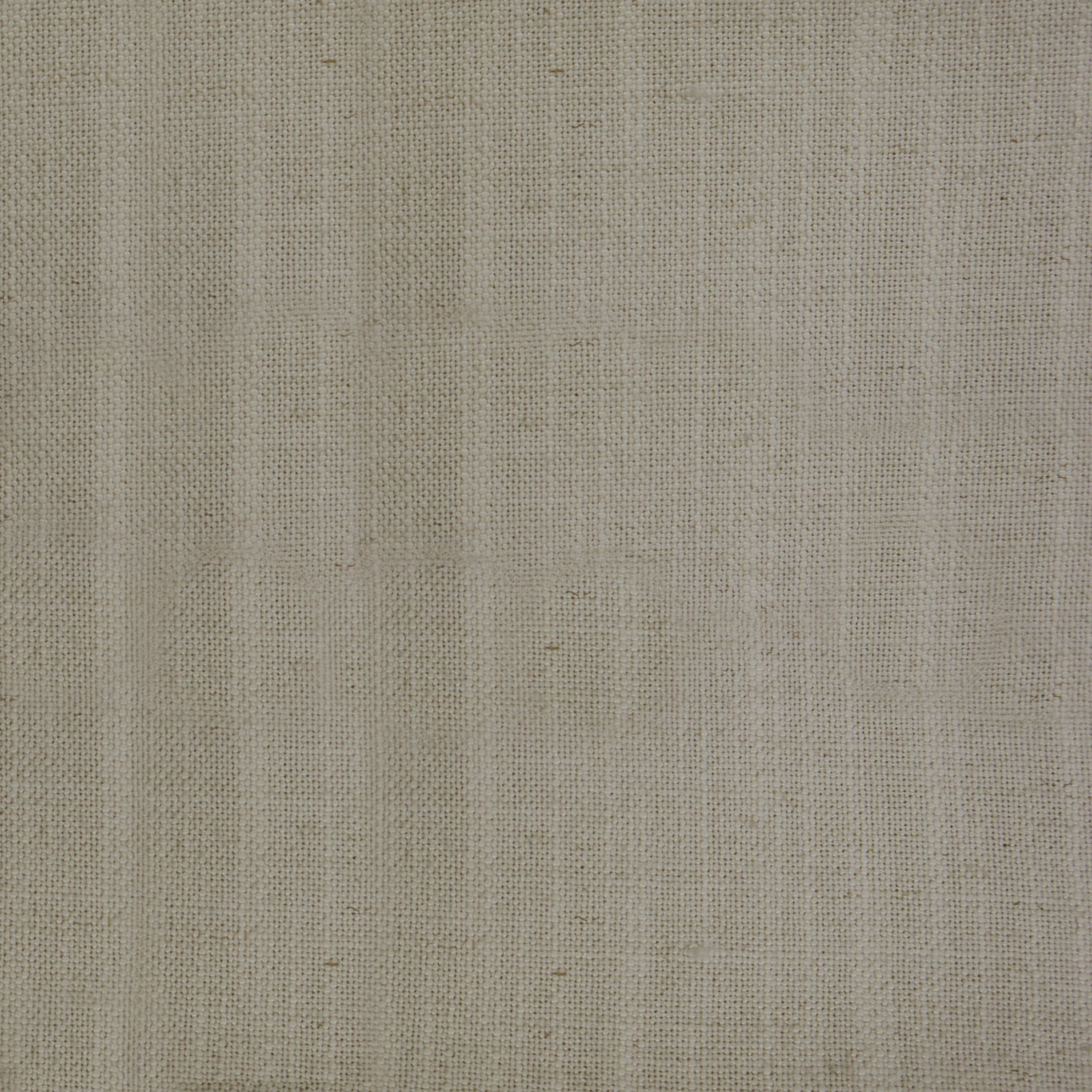 Close-up of warm cream woven fabric with fine slubby texture