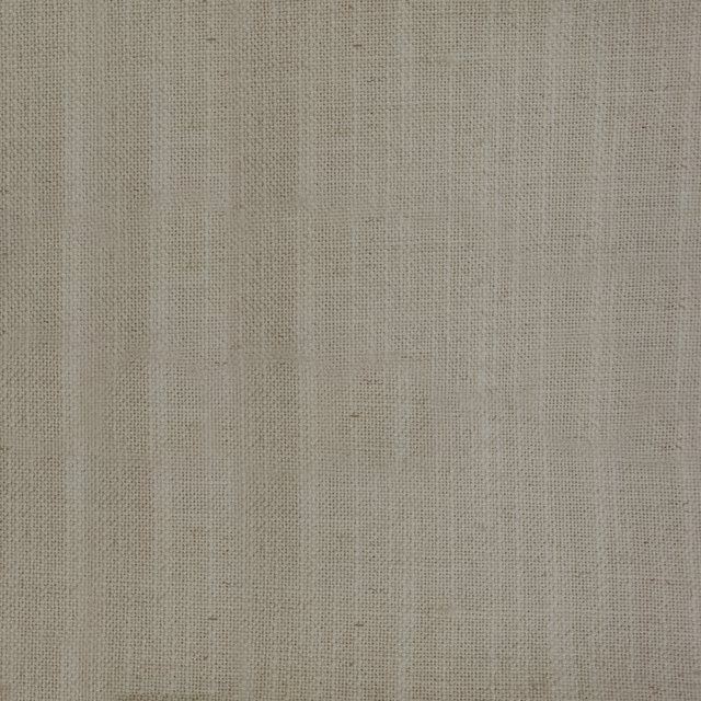 Close-up of warm cream woven fabric with fine slubby texture