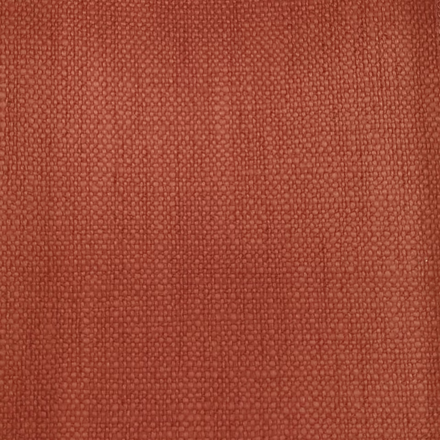 Close-up of a textured terracotta orange woven fabric with a tight plain weave
