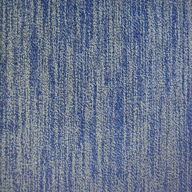 Close-up of mottled cobalt blue woven fabric with textured vertical striations