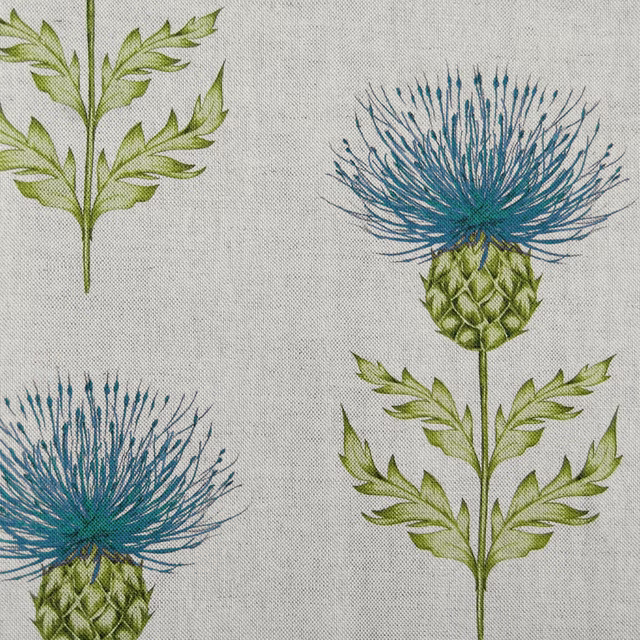 Large blue thistle flowers and green leaves printed on a pale linen-textured ground