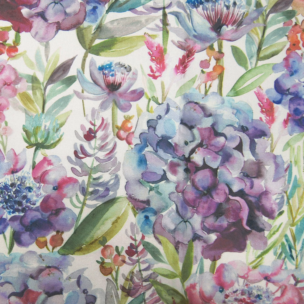 Watercolour hydrangea floral fabric in lilac, mauve, blue and green on a pale ground