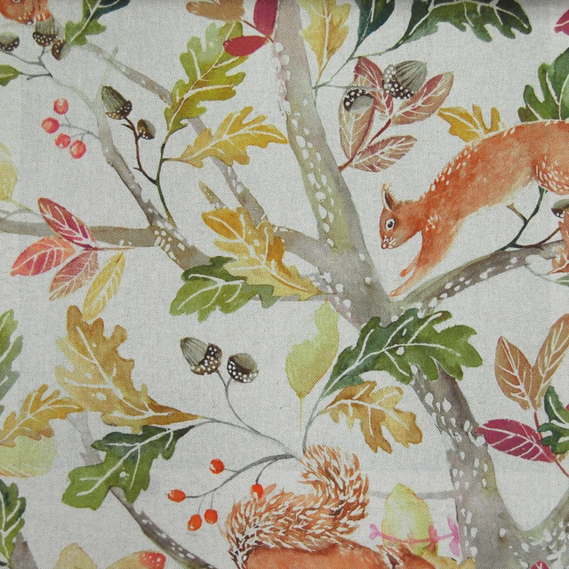 Woodland print fabric with foxes, squirrels, oak leaves and berries on a pale ground