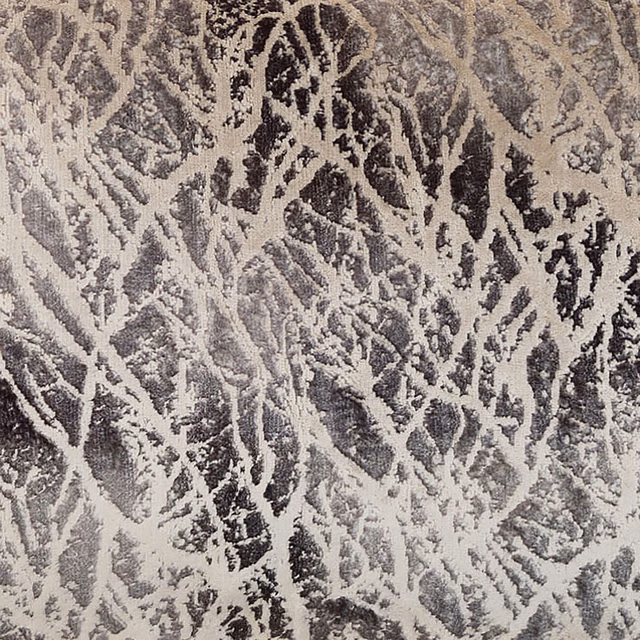 Close-up of a grey abstract jacquard with pale and charcoal branch-like pattern