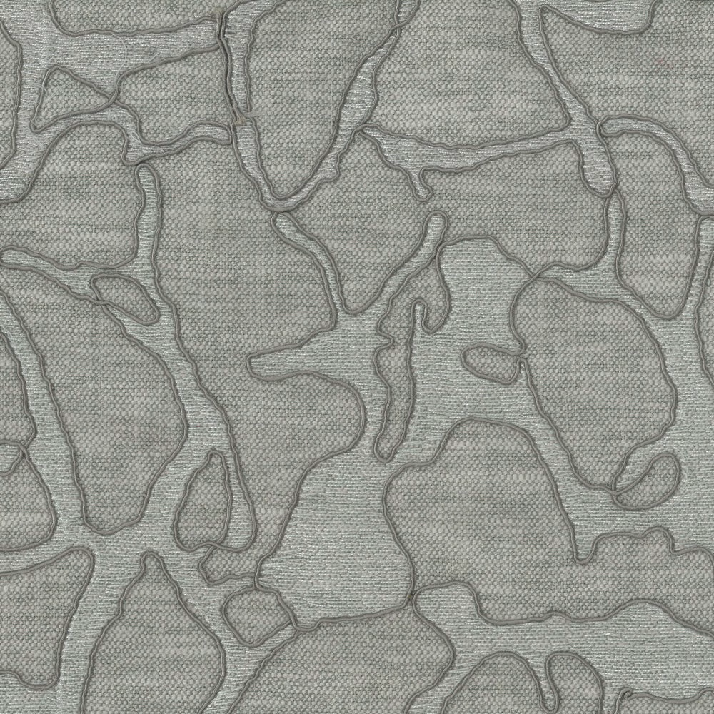 Soft misty blue abstract fabric with raised embroidered outlines on a woven ground