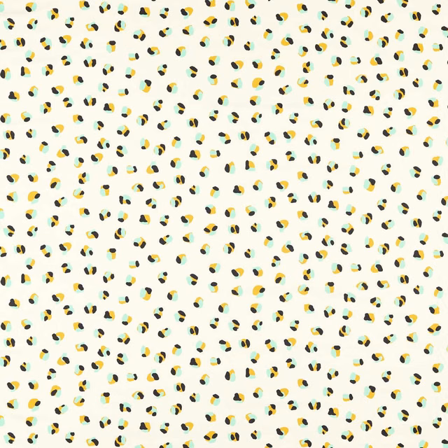 Pale ivory fabric with scattered pebble, sage and yellow leopard-like marks