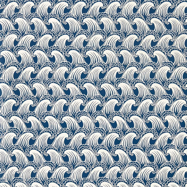 Dense ivory curling wave motifs repeating across a deep denim-blue ground