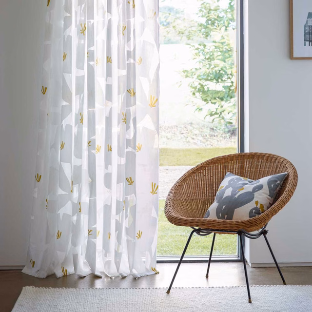 Ivory sheer curtain with grey abstract forms and scattered mustard-yellow sprigs