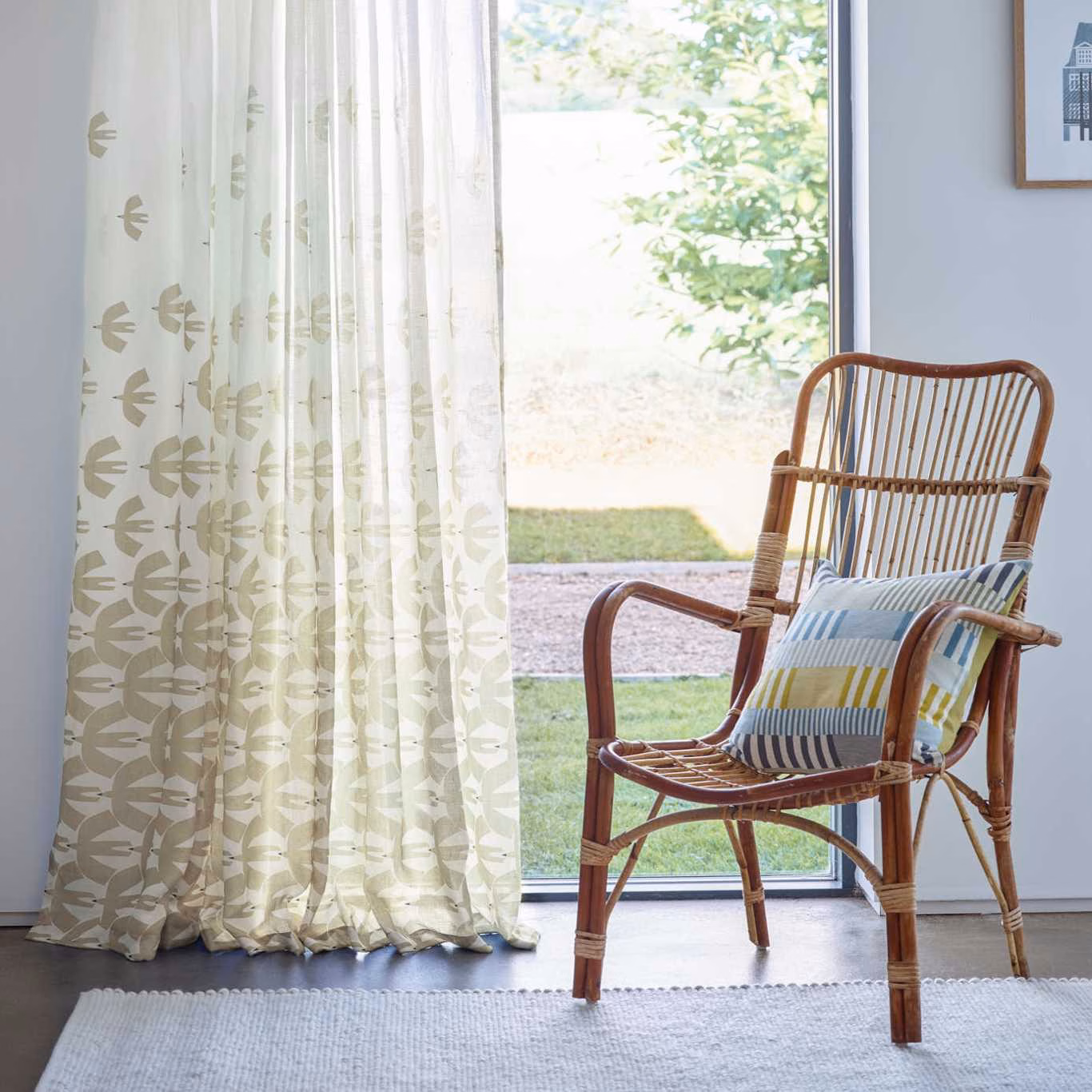 Pale ivory sheer curtain with muted sage-taupe fan-like botanical motifs