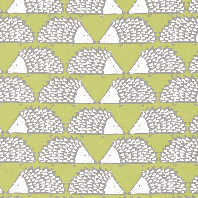 Kiwi green fabric with repeating grey and white hedgehog motifs