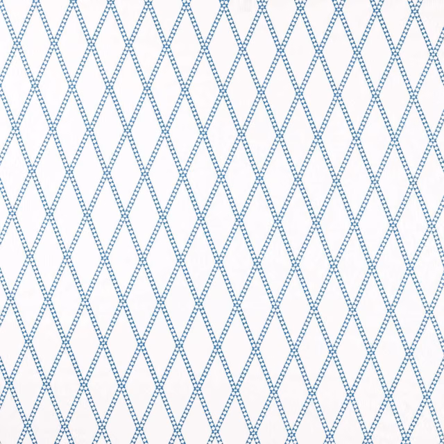 Cool denim-blue dotted diamond lattice embroidery on a pale white ground