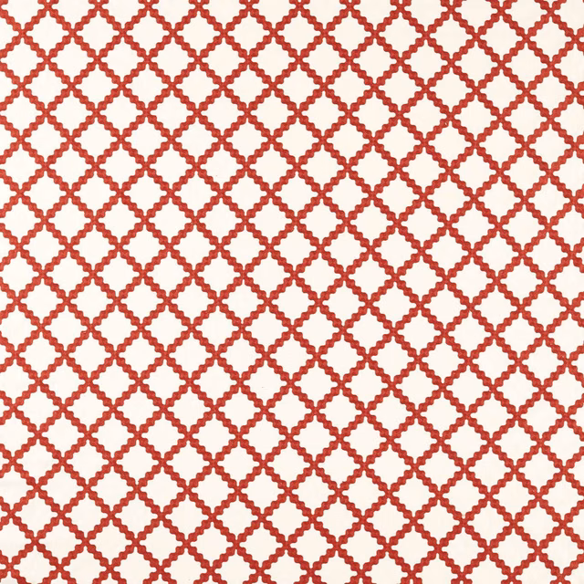 Warm red embroidered lattice on a cream ground, close-up textile texture