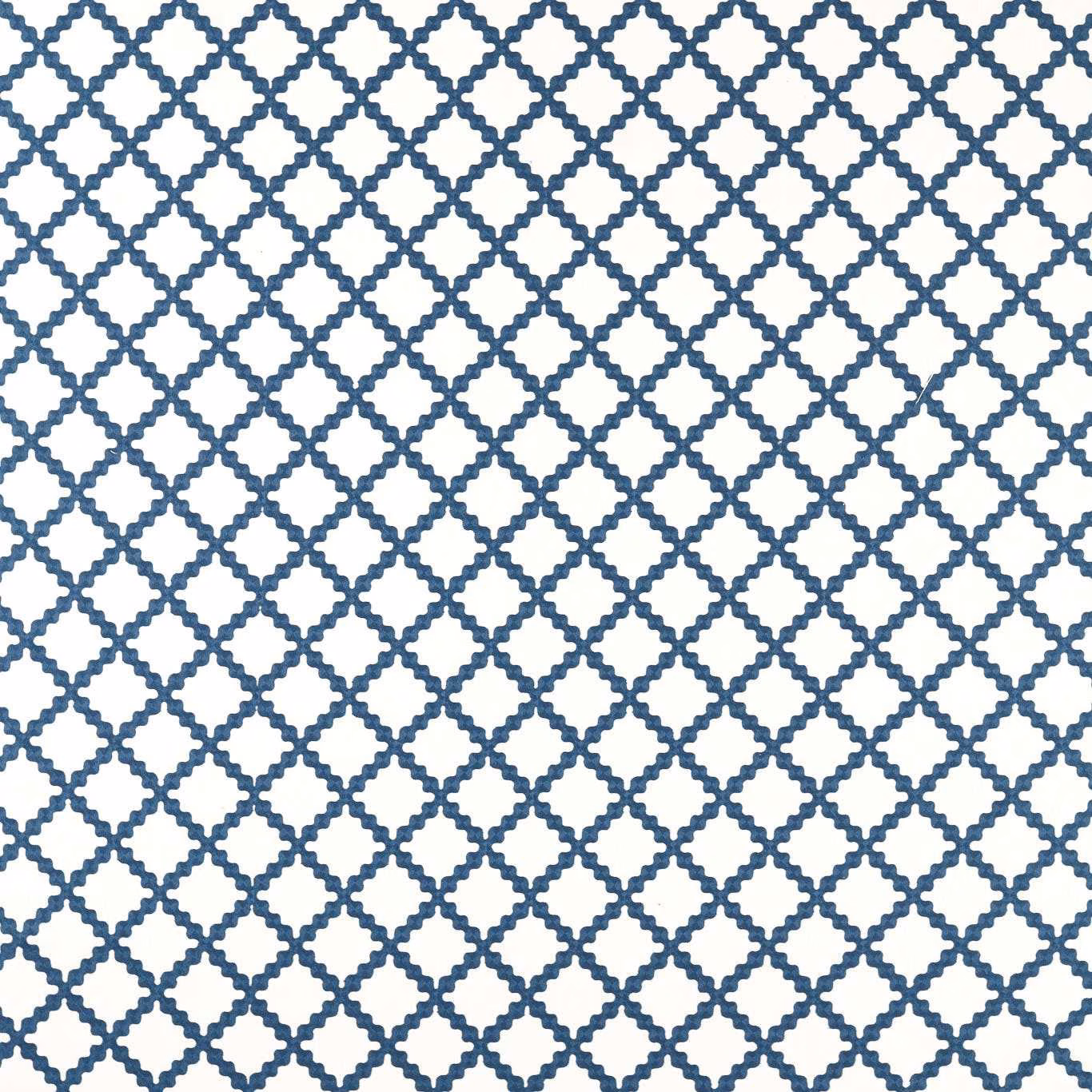 Midnight-blue geometric lattice embroidery on a crisp white fabric ground