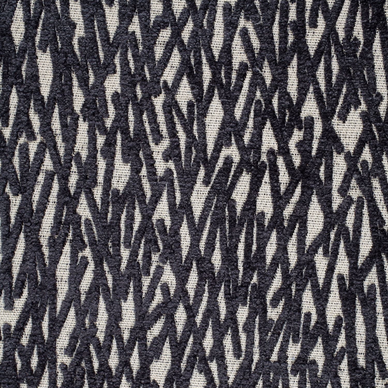 Midnight black and ivory abstract zigzag weave with a coarse, tactile textile surface