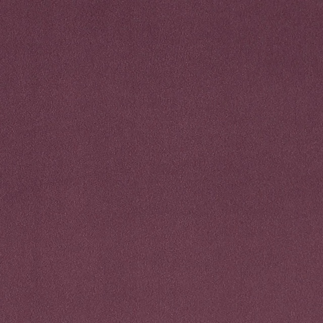 Close-up of muted heather-plum fabric with a softly mottled plain weave